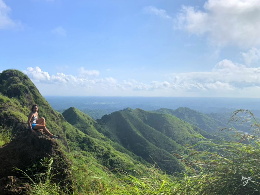 Mountain ridges, girl on a rock formation