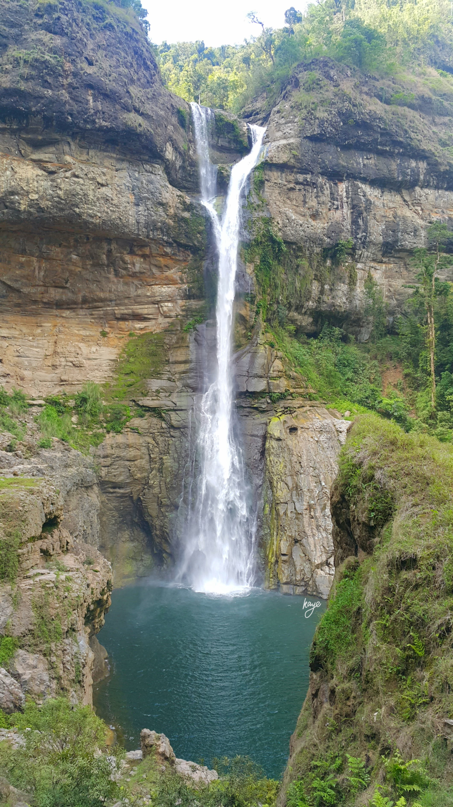 Tall waterfall with basin in a gorge