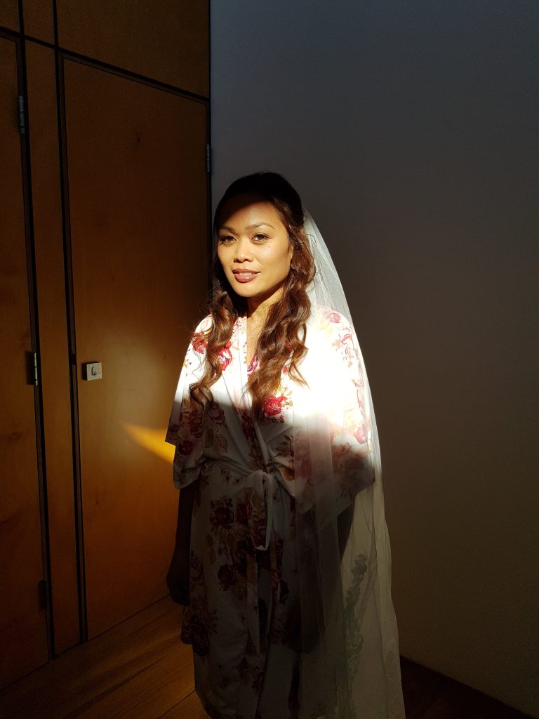 Girl in robe with bridal veil